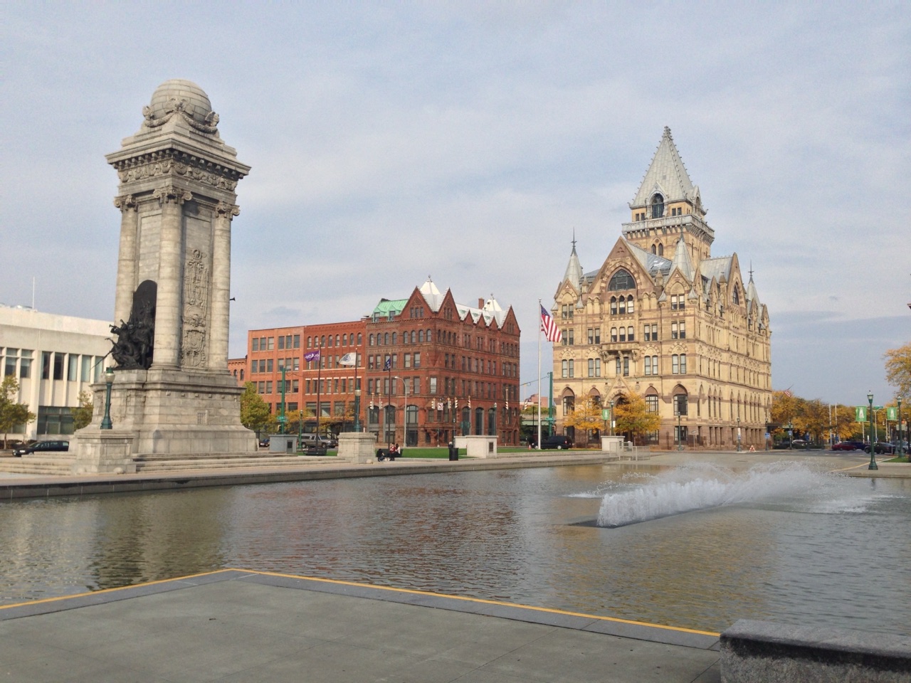 Clinton Square in downtown Syracuse with the Soldiers and Sailors Monument, a fountain pool and the Gothic Syracuse Savings Bank